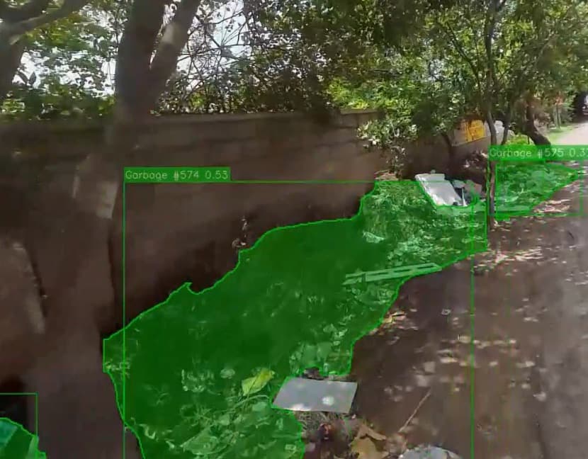The tagged capture: a garbage pile along a wall, outlined by the model