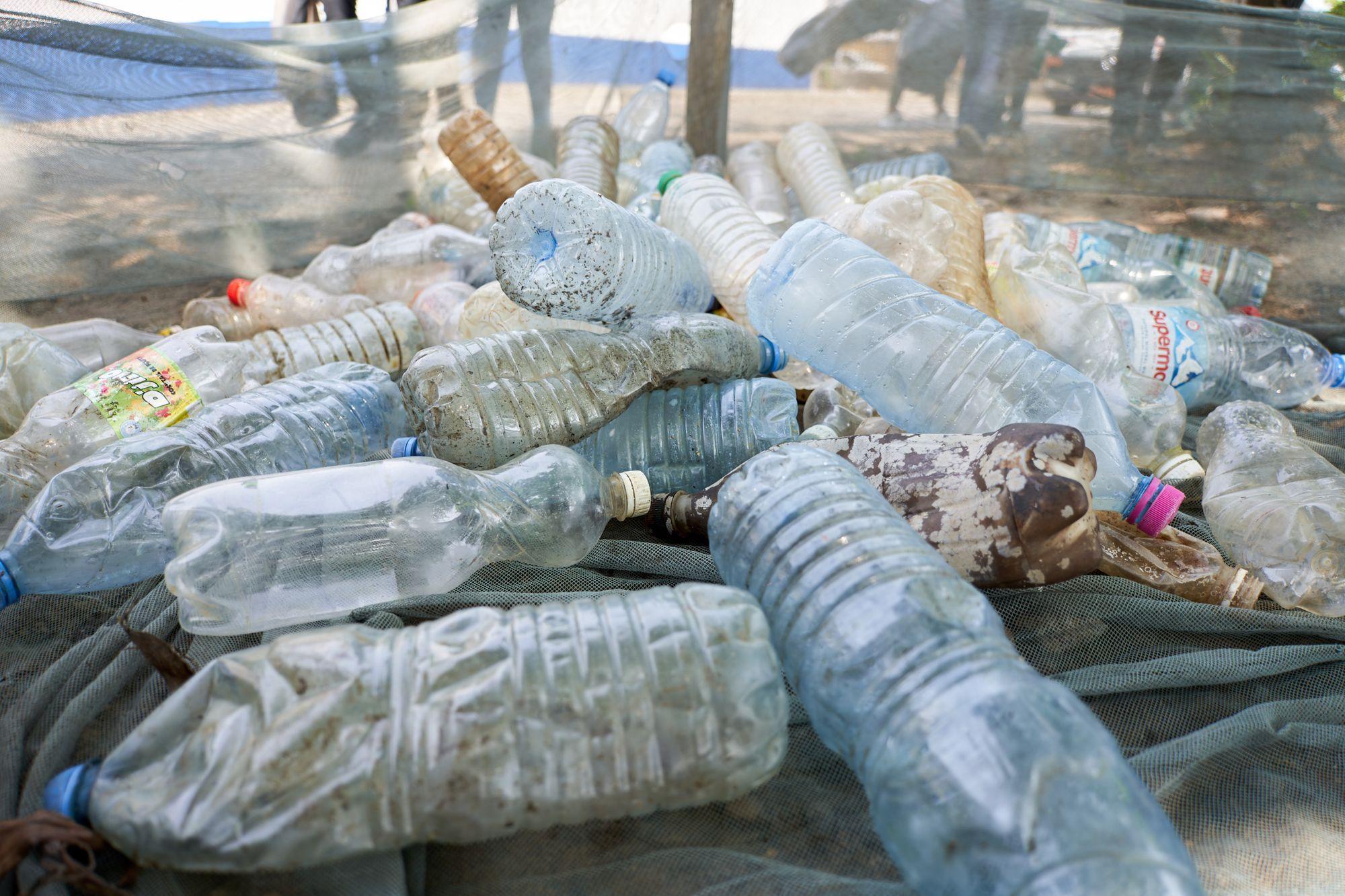 A close-up of discarded plastic water bottles heaped together